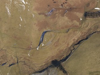 Oblique aerial view of Mossfennan fort and scooped settlement, settlement, and cultivation terraces, looking NE.