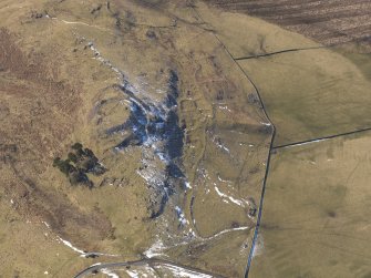 Oblique aerial view of Dreva Craig fort, settlements and field system, looking WSW.