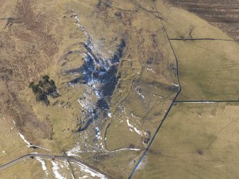 Oblique aerial view of Dreva Craig fort, settlements and field system, looking SW.