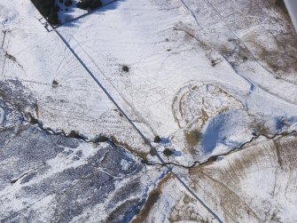 Oblique aerial view of Lour fort, tower, cultivation remains and rig under snow, looking W.
