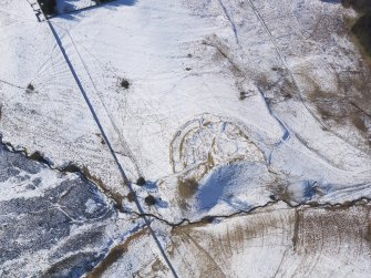 Oblique aerial view of Lour fort, tower, cultivation remains and rig under snow, looking SW.