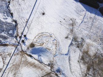 Oblique aerial view of Lour fort, tower, cultivation remains and rig under snow, looking S.