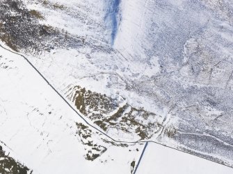 Oblique aerial view of fort and settlement under snow, looking WSW.