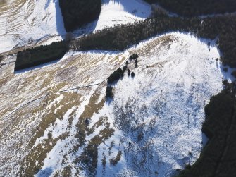 Oblique aerial view of settlement under snow, looking SSE.