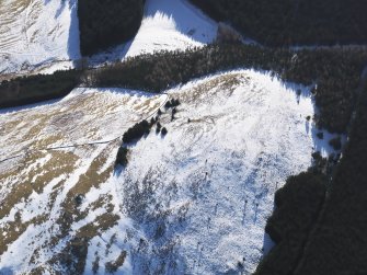 Oblique aerial view of settlement under snow, looking SSE.