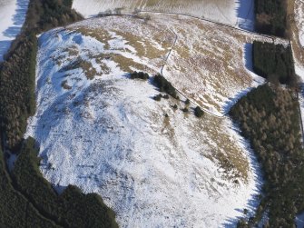 Oblique aerial view of settlement under snow, looking ENE.