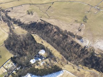 Oblique aerial view of the earthwork and Harden House, looking SW.