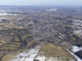 General oblique aerial view of Hawick with the Eildon Hills in the distance, looking NNE.