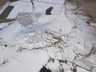 Oblique aerial view of the fort and settlements on Bonchester Hill, looking NNE.