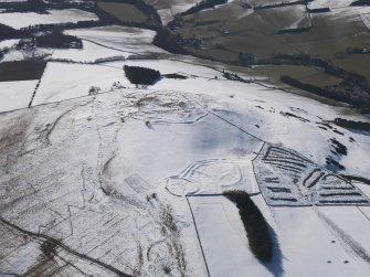 Oblique aerial view of the fort and settlements on Bonchester Hill, looking SW.