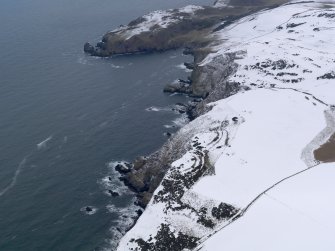 General oblique aerial view of the snow-covered remains of the fort at Earn's Heugh, taken from the W.