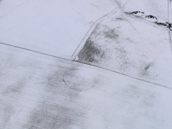 Oblique aerial view of the snow marks of the settlement at Black Loch, taken from the ENE.