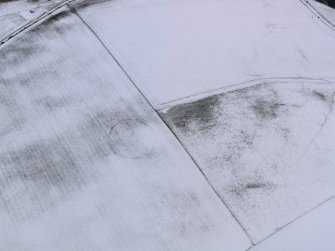 Oblique aerial view of the snow marks of the settlement at Black Loch, taken from the NNE.