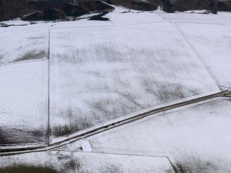 Oblique aerial view of the snow marks of the settlement at Black Loch, taken from the SSE.