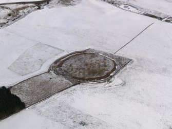 Oblique aerial view of the snow-covered remains of the fort at Black Castle, Newlands, taken from the WSW.
