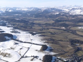 General oblique aerial view up the River Earn with the snow-covered mountains beyond, looking NW.