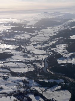 General oblique aerial view of Aberfeldy under snow with Loch Tay in the distance, looking SW.