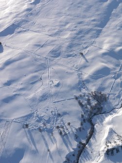 Oblique aerial view of the townships and the military road, looking W.