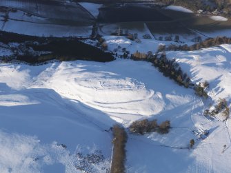 Oblique aerial view of Castle Law fort under snow, looking NNE.