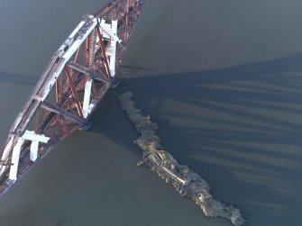 Oblique aerial view centred on the bridge pier, looking NW.