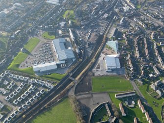 Oblique aerial view of Lanark centred on the retail park and sports centre, taken from the E.