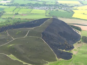 Oblique aerial view of the burnt heather moorland on Eildon Wester Hill with Bowden village beyond, taken from the NNW.