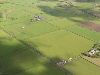 Oblique aerial centred on the rectilinear field pattern between the two farms, taken from the SW.