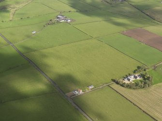 Oblique aerial centred on the rectilinear field pattern between the two farms, taken from the SW.
