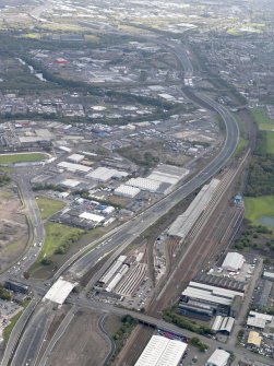 Oblique aerial view of the city showing the route of the M74 extension going from the Polmadie area to Dalbeth bridge centred on the Power Motive Works, taken from the W.