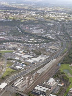 Oblique aerial view of the city showing the route of the M74 extension going from the Polmadie area to Dalbeth bridge centred on the Power Motive Works, taken from the W..