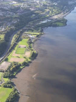 General oblique aerial view looking across the remains of the timber ponds and the playing fields towards Port Glasgow, taken from the ENE.