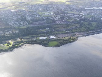 General oblique aerial view looking across the remains of the timber ponds towards Port Glasgow, taken from the NE.