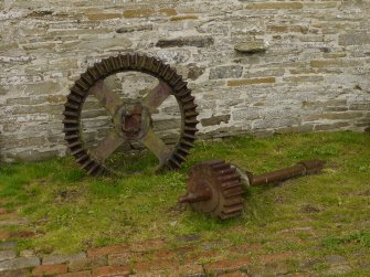 Detail of great spur wheel used as garden 'sculpture'.