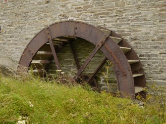 View of original water wheel with modern replacement buckets.