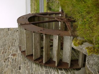 View of original water wheel with modern replacement buckets.