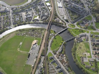 Oblique aerial view of the city, centred on the three bridges across the River Forth at Causewayhead, taken from the N.