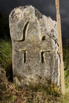View of small cross incised stone (with scale)