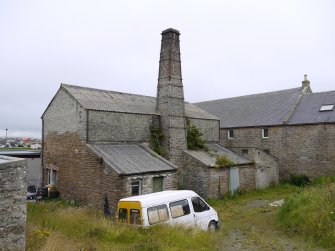 General view from NW. The lean to buildings housed the exausters (left) and the purifiers (right). By 1959, there wer two gasholders, one of which was disused