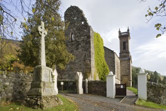 General view from South-West towards Collegiate Church of St Mun. Boundary walls and War Memorial in foreground and Kilmun Kirk in background.
