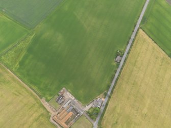 Oblique aerial view of the cropmarks of the ring ditch, looking SE.