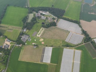 Oblique aerial view of the spitfire maze at Cairney Lodge, looking NNW.