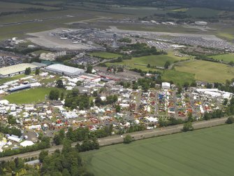 General oblique aerial view of the Royal Highland Showground with Edinburgh airport in the background, taken from the SSW.