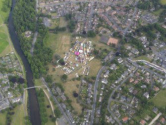Oblique aerial view of the fair in Victoria Park, Peebles, taken from the WNW.