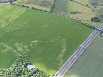 Oblique aerial view of the cropamrks of the possible coal pits and other pits, taken from the NE.