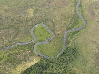 Oblique aerial view of the roofless shells of the buildings of Dalnahsaig and the meander in the River Add, taken from the N.