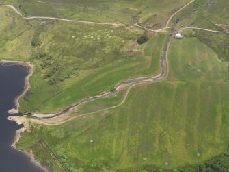 Oblique aerial view of the grassmarks of the possible barrow at Cnocbreac, Jura, taken from the NW.