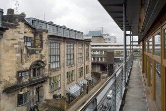 View looking west along external walkway on south elevation of Foulis building, with Mackintosh building to left and Bourdon building to background.