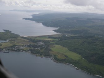 General oblique aerial view looking down Kintyre across Carradale village, taken from the NE.