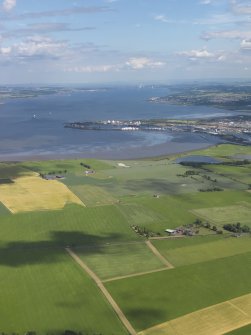 General oblique aerial view looking across Gragemouth down the Forth towards the bridges, taken from the W.