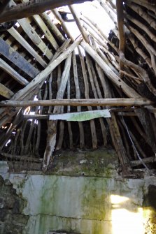 Interior. View of the timber roof structure within the North room of the traditional thatched cottage at 4 Balevullin. The remains of plaster can also be seen to the walls.